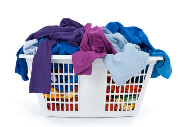 Colorful clothes in laundry basket. Blue, indigo, purple.