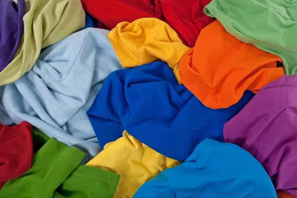 Messy roupas coloridas fundo — Fotografia de Stock
