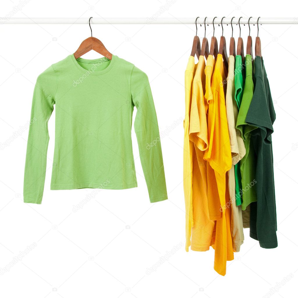 Green and yellow shirts on wooden hangers