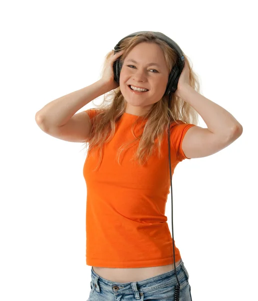 Smiling girl listening to music in headphones — Stock Photo, Image
