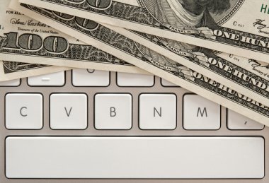 Money bills on computer keyboard with spacebar clipart