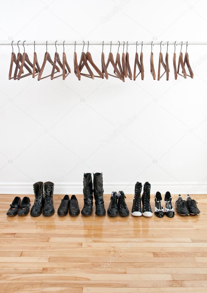 Row of shoes and empty hangers