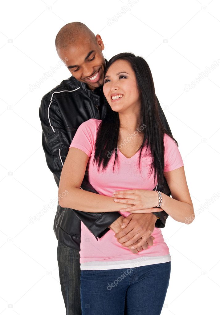 Young couple embracing and smiling