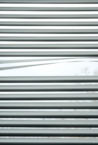 Peeking through venetian blinds — Stock Photo, Image