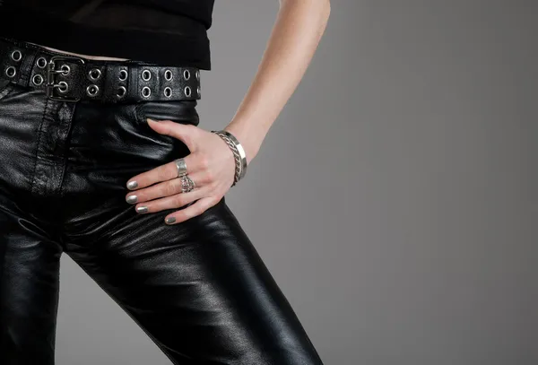 Leather pants and hand with silver jewellery — Stock Photo, Image