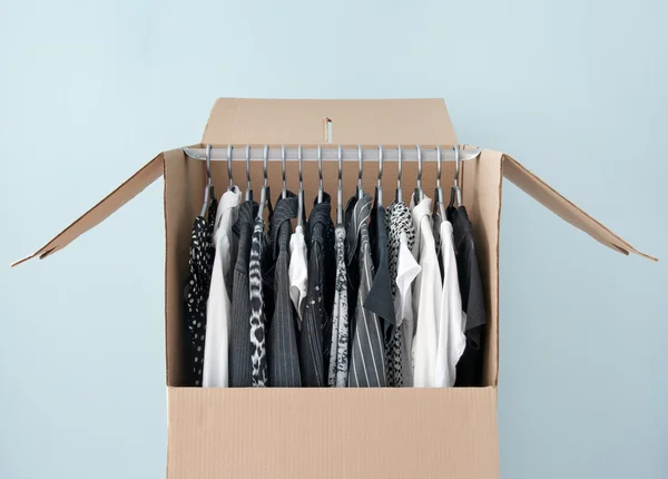 Clothes in a wardrobe box for easy moving — Stock Photo, Image