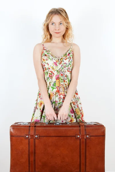 Girl with vintage suitcase anticipating travel — Stockfoto