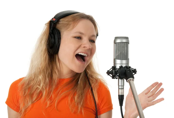 Singer in headphones singing with the microphone — Stock Photo, Image