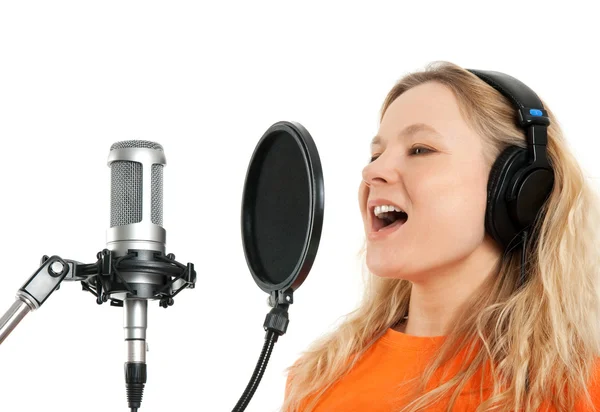 Girl in headphones singing with studio microphone — Stock Photo, Image