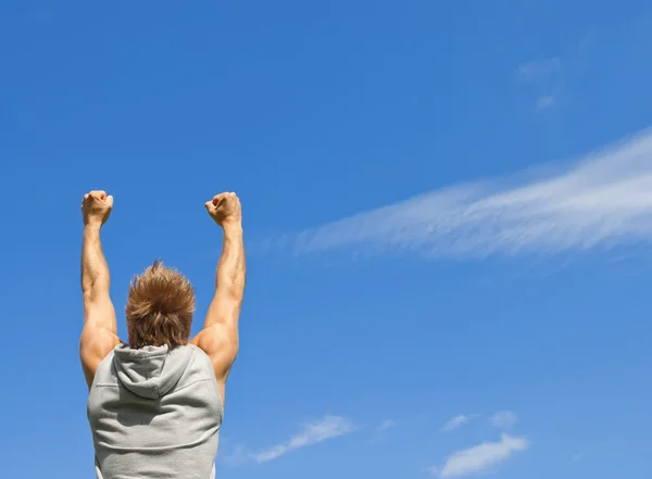 Sporty guy with his arms raised in joy — Stock Photo, Image