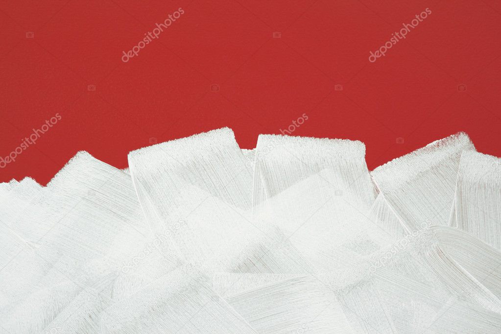 Red wall painted in white with paint roller