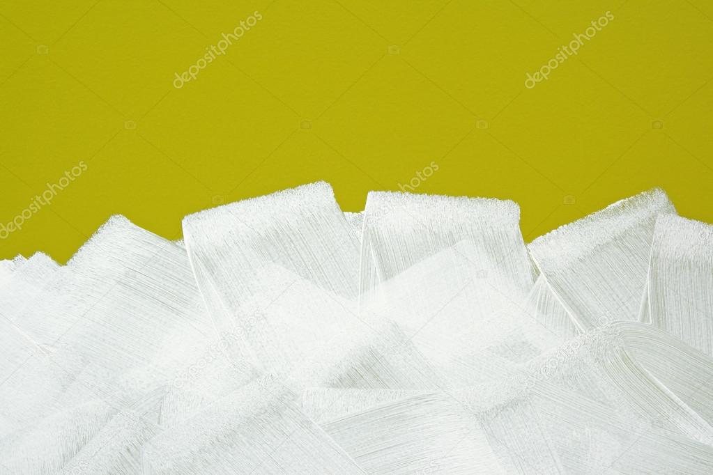 White brush strokes texture on yellow wall