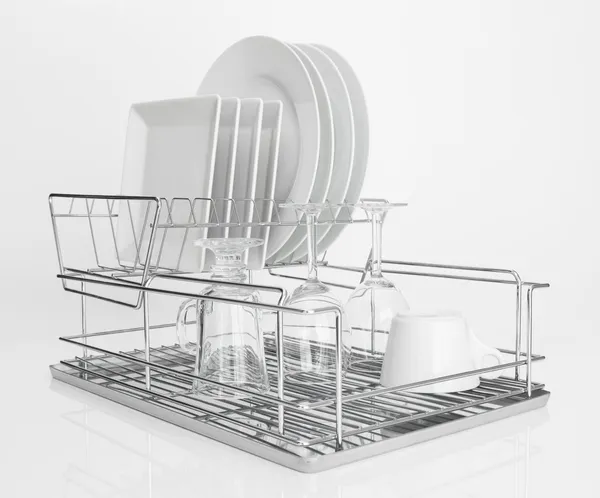 White dishes drying on metal dish rack