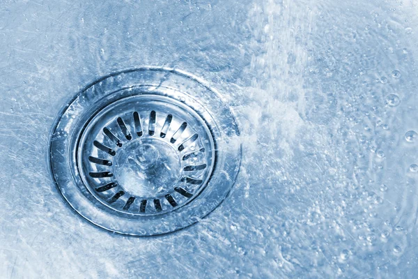 Pure water running into kitchen sink drain — Stock Photo, Image