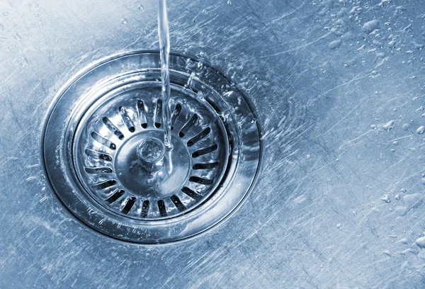 Water running into kitchen sink drain — Stock Photo, Image