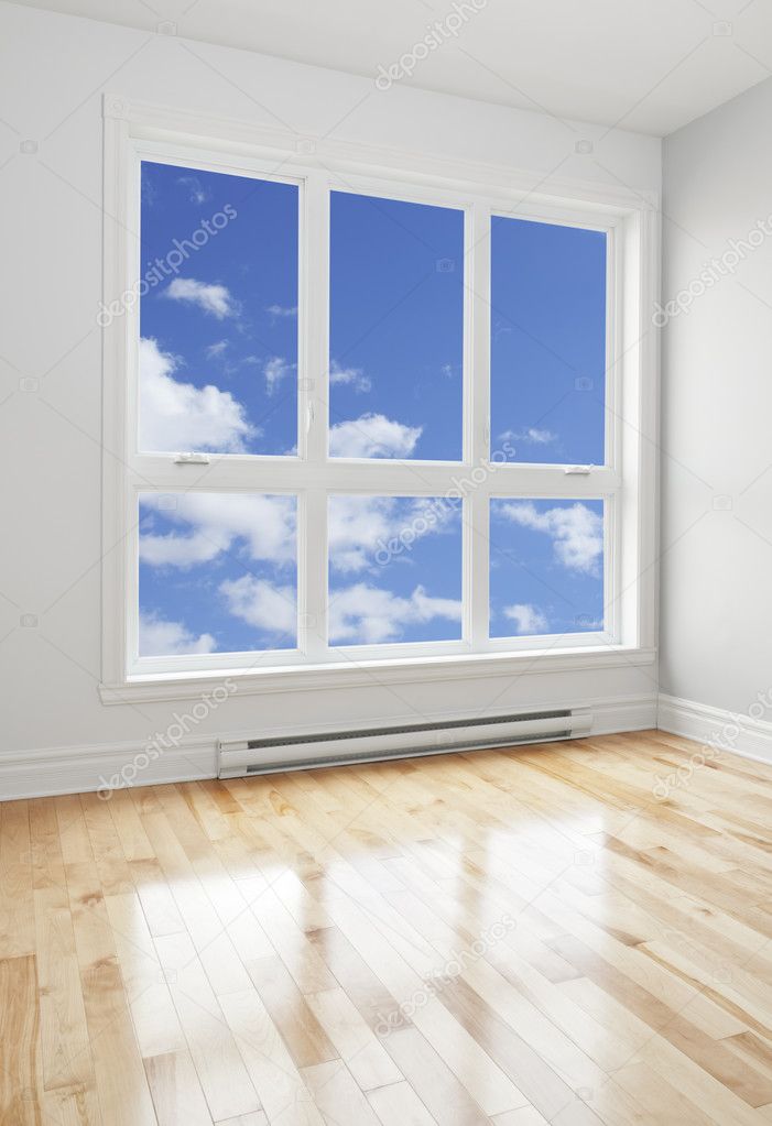 Empty room and blue sky seen through the window
