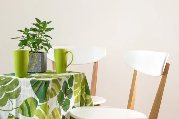 Яркий зеленый стол с чашками — стоковое фото