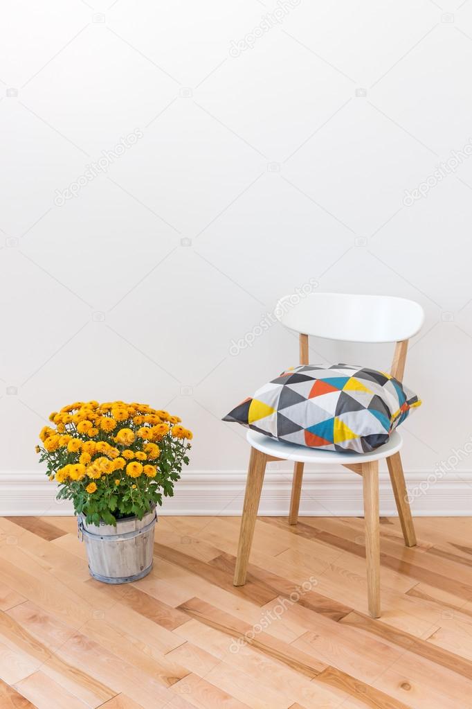 Orange chrysanthemums bright cushion on a chair