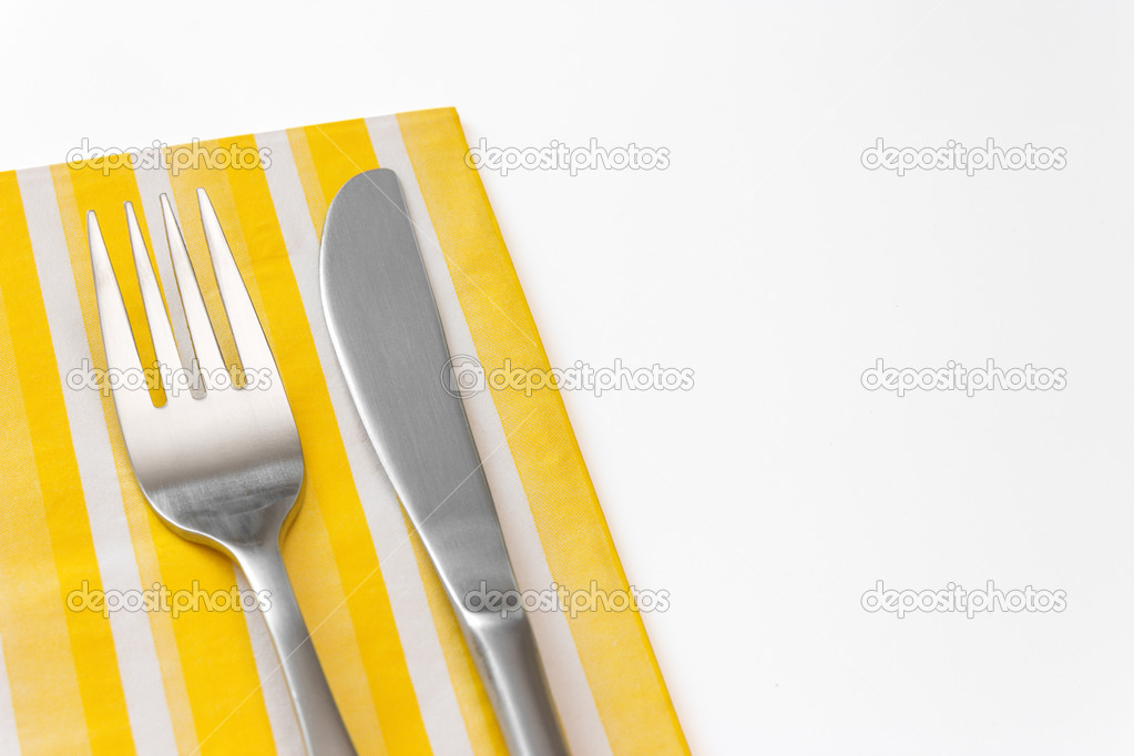Fork and knife on a yellow napkin