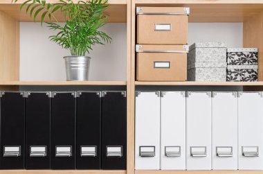 Shelves with boxes, folders and green plant clipart