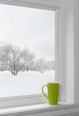 Green cup on a windowsill clipart