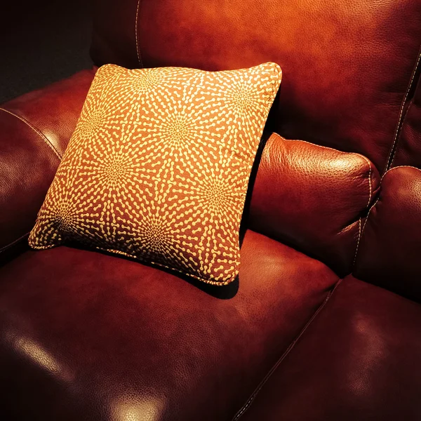 Red leather sofa with cushion — Stock Photo, Image