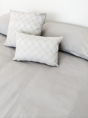Grey bed linen and pillows clipart