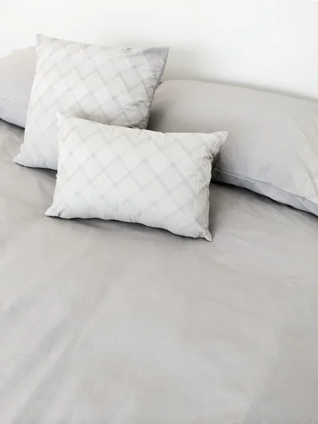 Grey bed linen and pillows — Stock Photo, Image