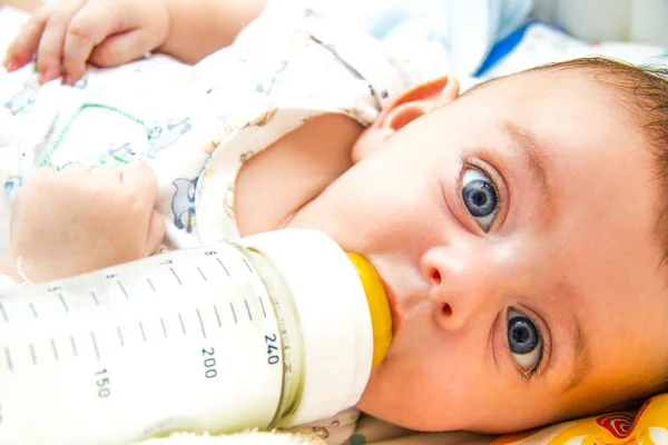 Baby and milk bottle — Stock Photo, Image