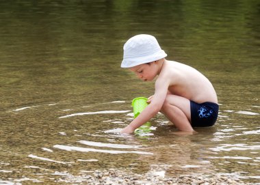 Child playing in river clipart