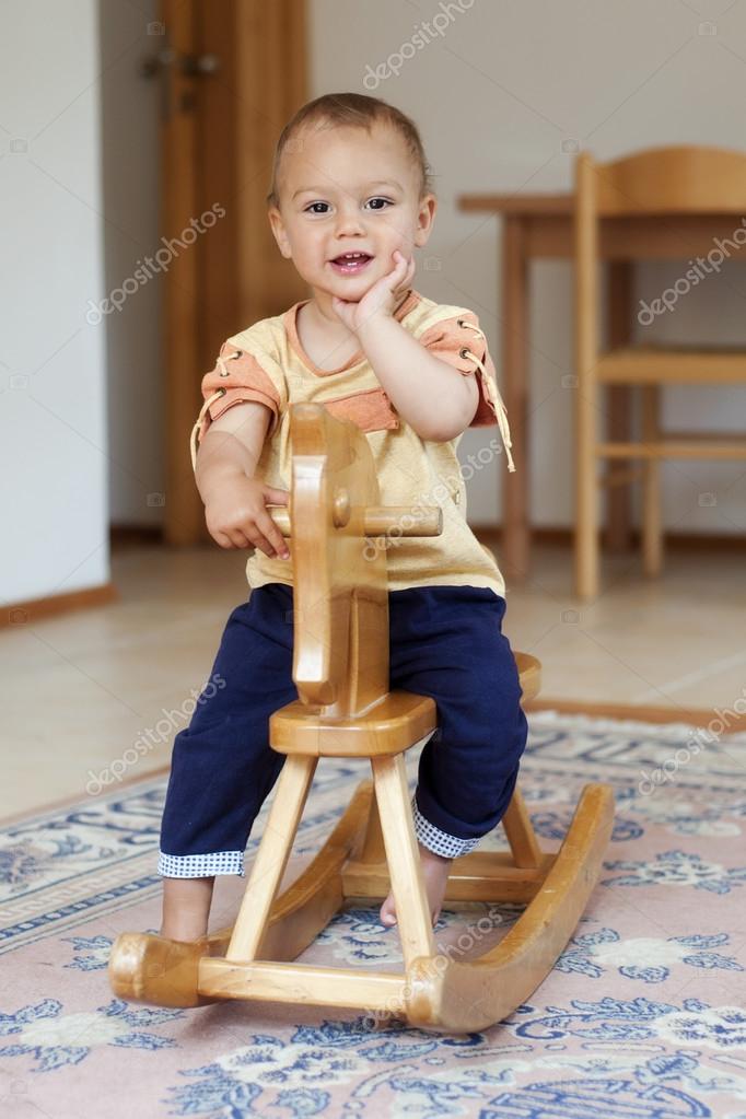 child on rocking horse