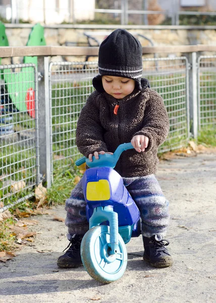 Child on toy bike — 图库照片