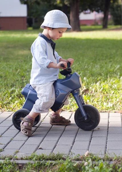 Child on toy bike — 图库照片