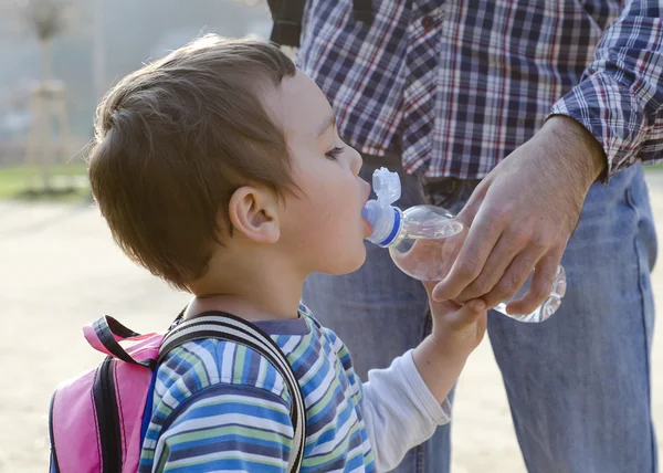 Child drinking water from a bottle — Stock Photo, Image