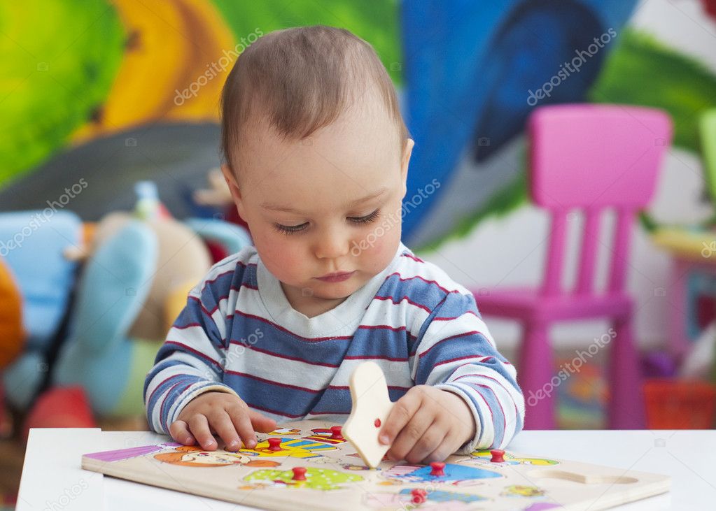 Toddler child playing with puzzle Stock Photo by ©pavsie 46248707