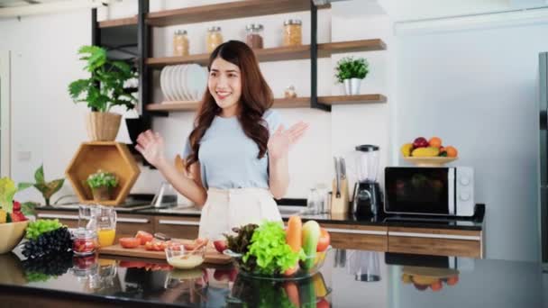Happy Young Asian Woman Waving Hands While Preparing Healthy Salad — Video Stock
