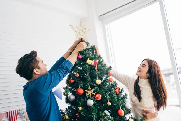 Happy Young Couple Wearing Sweaters Having Fun Decorating Various Baubles — Stock Photo, Image