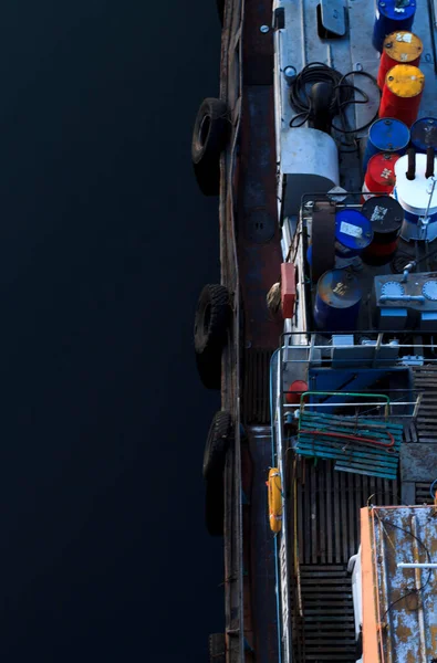 Deck of a ship with various items on the background of the river