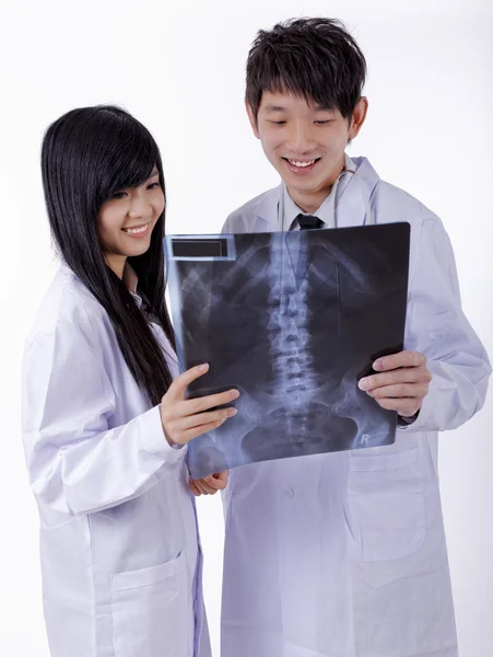 Two male woman medical doctors looking at x-rays in a hospital — Stock Photo, Image