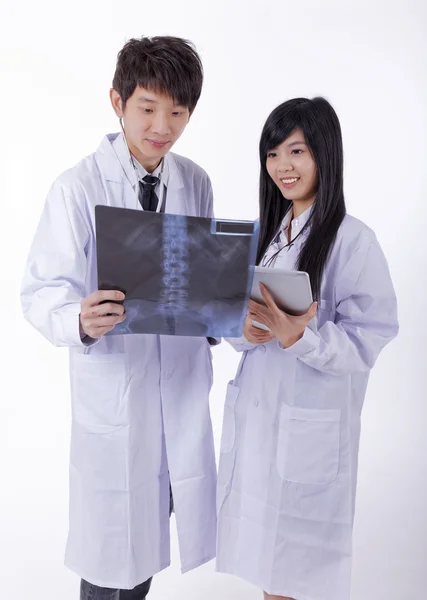 Two male woman medical doctors looking at x-rays in a hospital — Stock Photo, Image