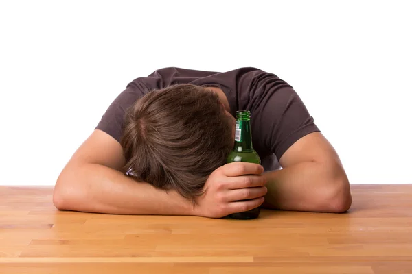 Man sleeping on a table with beer — Stock Photo, Image