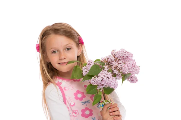 Happy little girl with lilac flowers — Stock Photo, Image