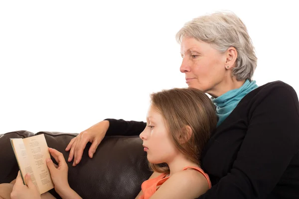 Grandmother read a book with her granddaughter — Stock Photo, Image