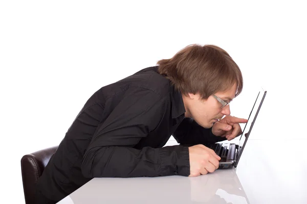 Sleepy business man look closely his laptop — Stock Photo, Image