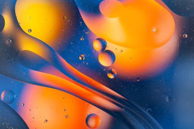 Colorful oil bubbles in water. Space, biology, phycics or chymistry abstract background.