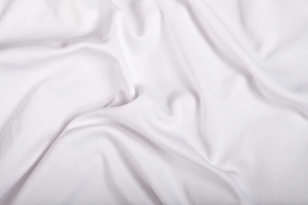 Fundo têxtil branco com dobras — Fotografia de Stock