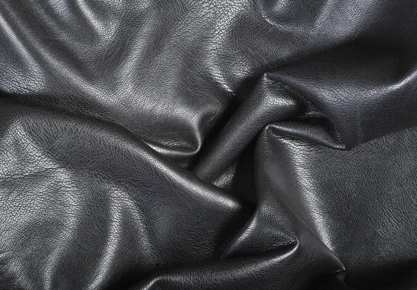 Schwarzer Lederhintergrund mit Falten — Stockfoto