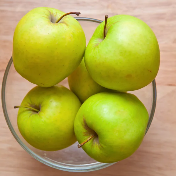 Green apples in a glass bowl — Stock Photo, Image