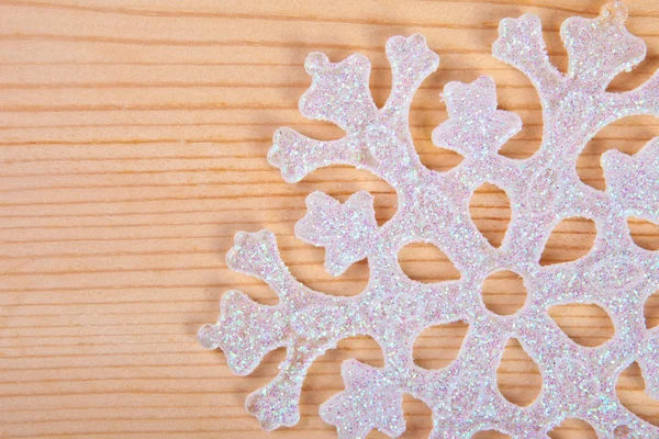 Snowflake on a wooden background — Stock Photo, Image