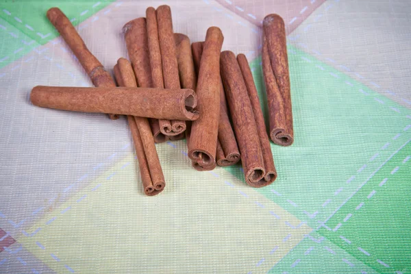 Cinnamon sticks on a plaid background — Stock Photo, Image